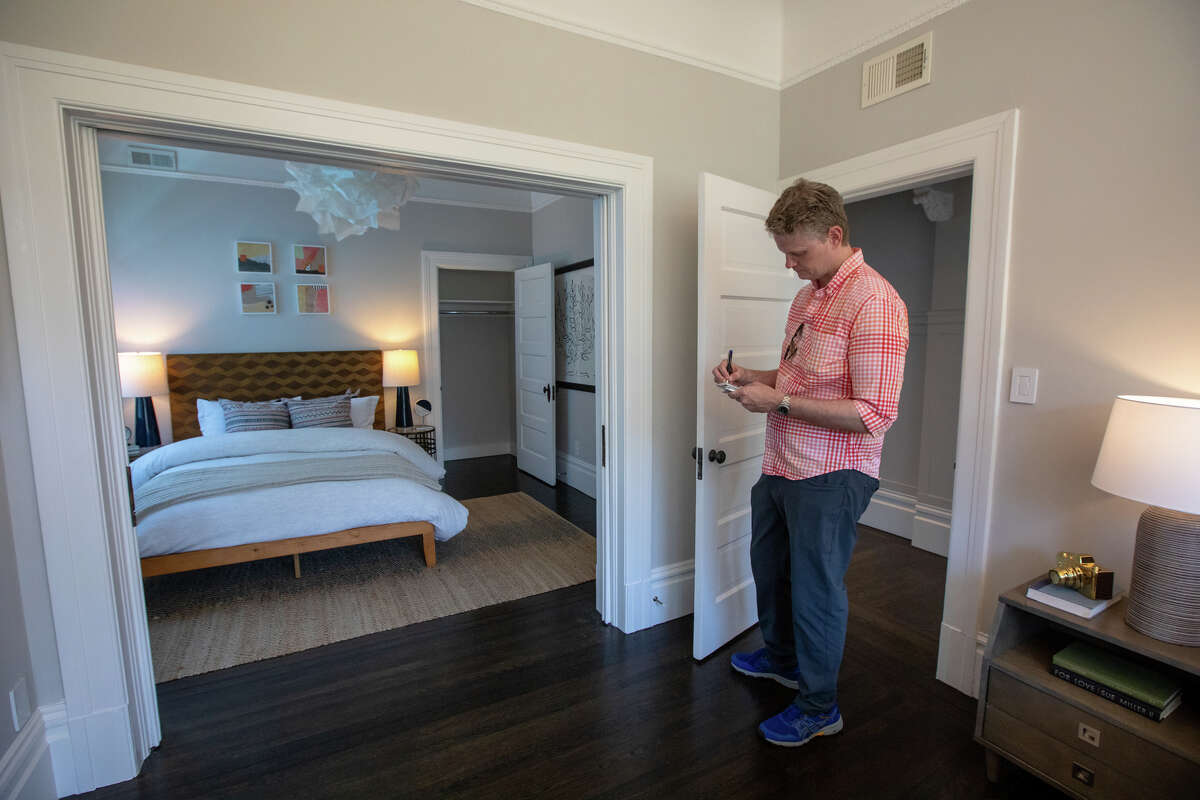SFGATE columnist Drew Magary takes some notes while inspecting 3732 20th Street, a condo for sale in San Francisco, Calif. on May 24, 2022. He is inspecting the state of the real estate market in San Francisco.