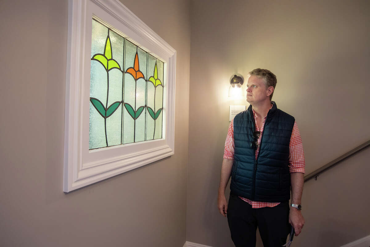 SFGATE columnist Drew Magary inspects a stained glass window inside 231 12th Avenue, a house for sale in San Francisco, Calif. on May 24, 2022. He is inspecting the state of the real estate market in San Francisco.