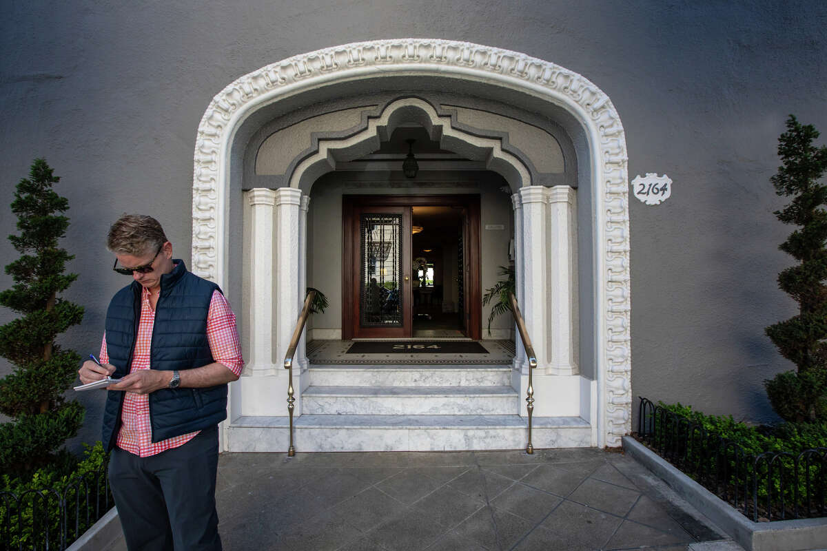 SFGATE columnist Drew Magary takes some notes before checking out 2164 Hyde St., No. 408, a co-op unit for sale in San Francisco on May 24, 2022. He is inspecting the state of the real estate market in San Francisco.