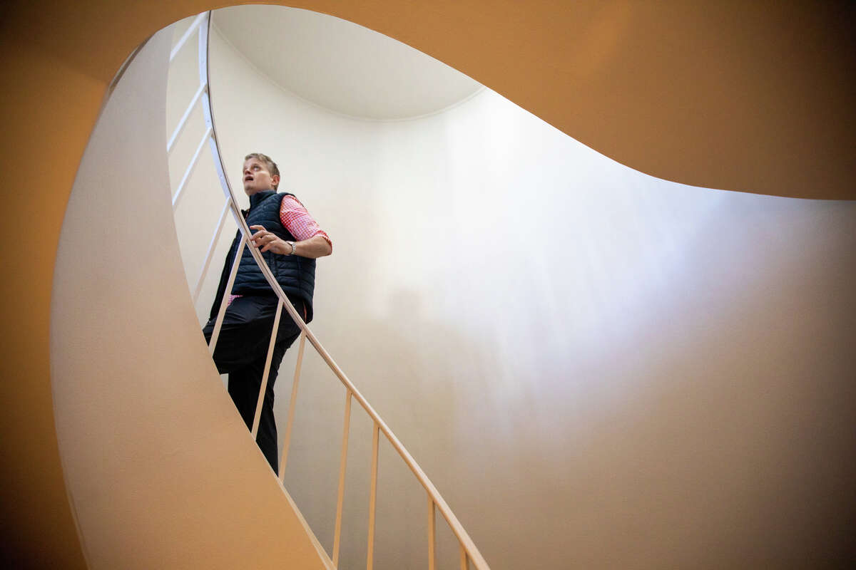 SFGATE columnist Drew Magary walks up a staircase at 1160 Greenwich Street #300 a condo for sale in San Francisco, Calif. on May 24, 2022. He is inspecting the state of the real estate market in San Francisco.