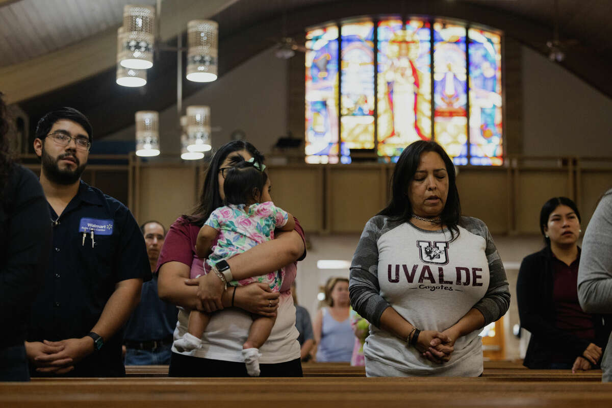 Parishioners mourn at Sacred Heart Catholic Church on May 25, 2022 in Uvalde, Texas. On May 24, 21 people were killed, including 19 children, during a mass shooting at Robb Elementary School. The shooter, identified as 18-year-old Salvador Ramos, was reportedly killed by law enforcement. (Photo by Jordan Vonderhaar/Getty Images)