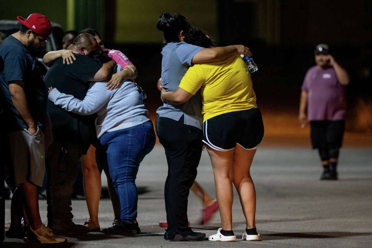 UVALDE, TEXAS - MAY 24: A family grieves outside of the SSGT Willie de Leon Civic Center following the mass shooting at Robb Elementary School on May 24, 2022 in Uvalde, Texas. According to reports, 19 students and 2 adults were killed, with the gunman fatally shot by law enforcement. (Photo by Brandon Bell/Getty Images)