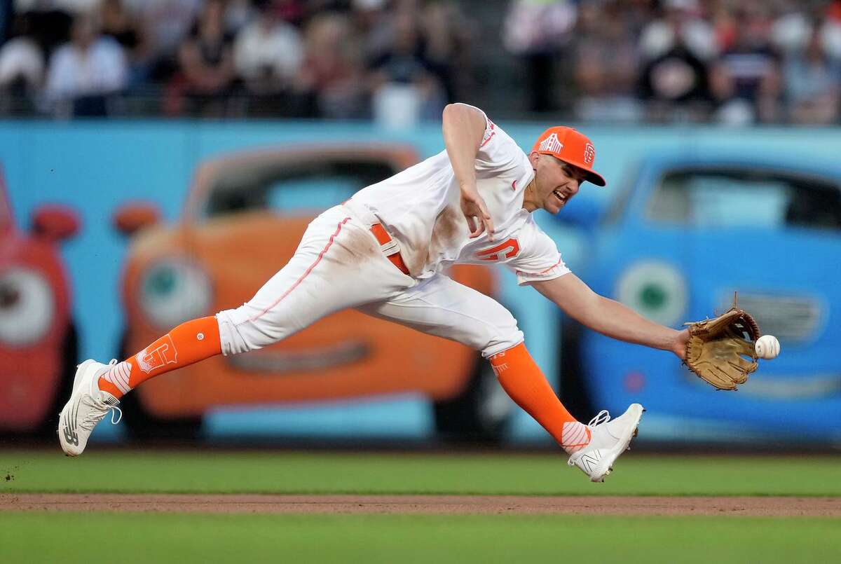 San Francisco Giants third baseman Kevin Padlo makes a stop on a grounder by New York Mets' Mark Canha during the fourth inning of a baseball game in San Francisco, Tuesday, May 24, 2022. Padlo threw to second base for the force on Jeff McNeil. (AP Photo/Tony Avelar)