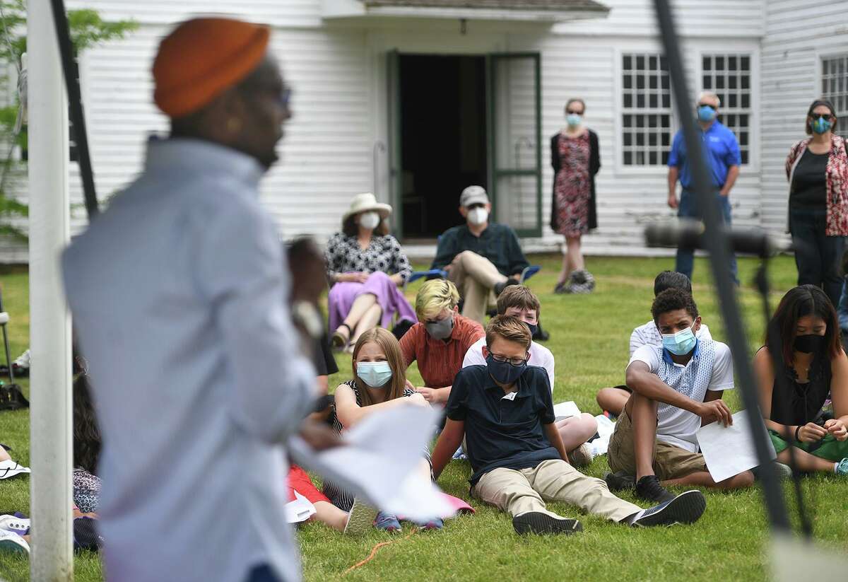 Hartford Poet Laureate Frederick Douglass Knowles reads a poem he wrote in honor of former slave Pink Primus outside the Pardee-Morris House in New Haven June 2, 2021. Students from The Foote School placed a witness stone in her honor outside the house where she and her husband were enslaved.