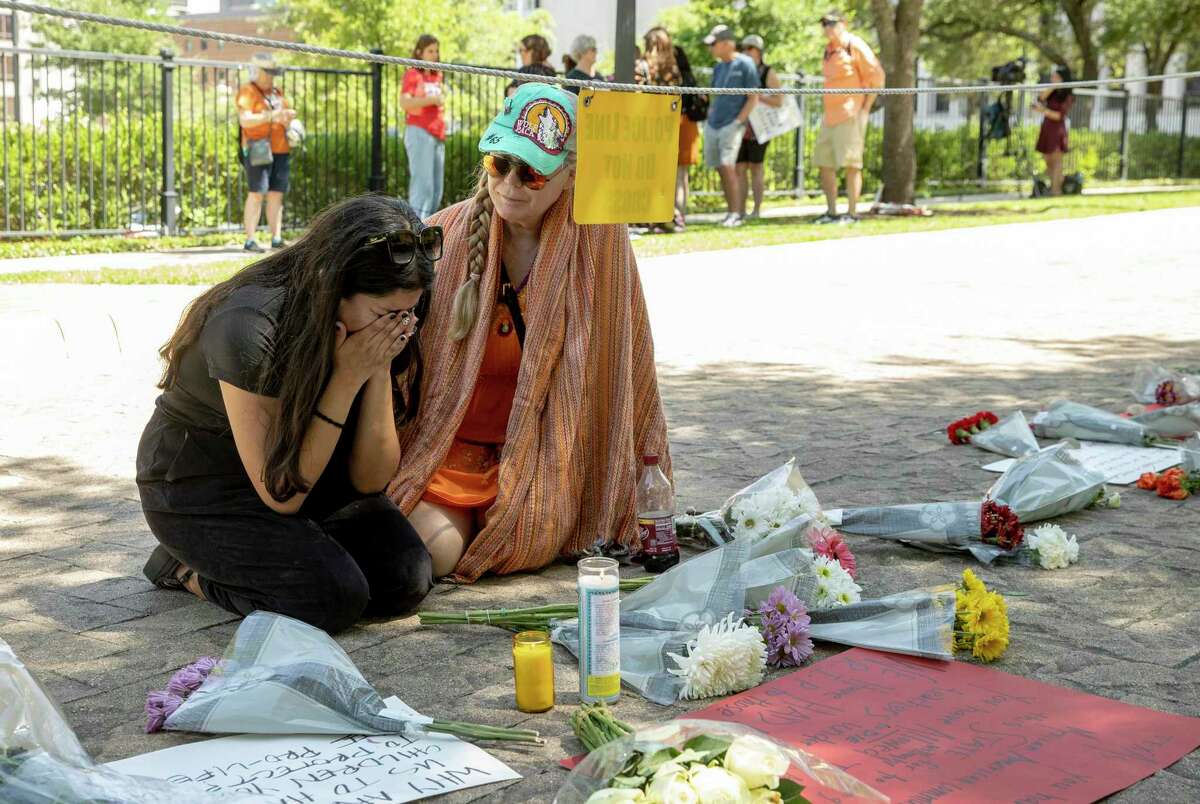 Iliana Calles cries at the Governor's Mansion, in Austin, Texas, during a protest organized by Moms Demand Action on Wednesday May 25, 2022, after a mass shooting at an elementary school in Uvalde, Texas.