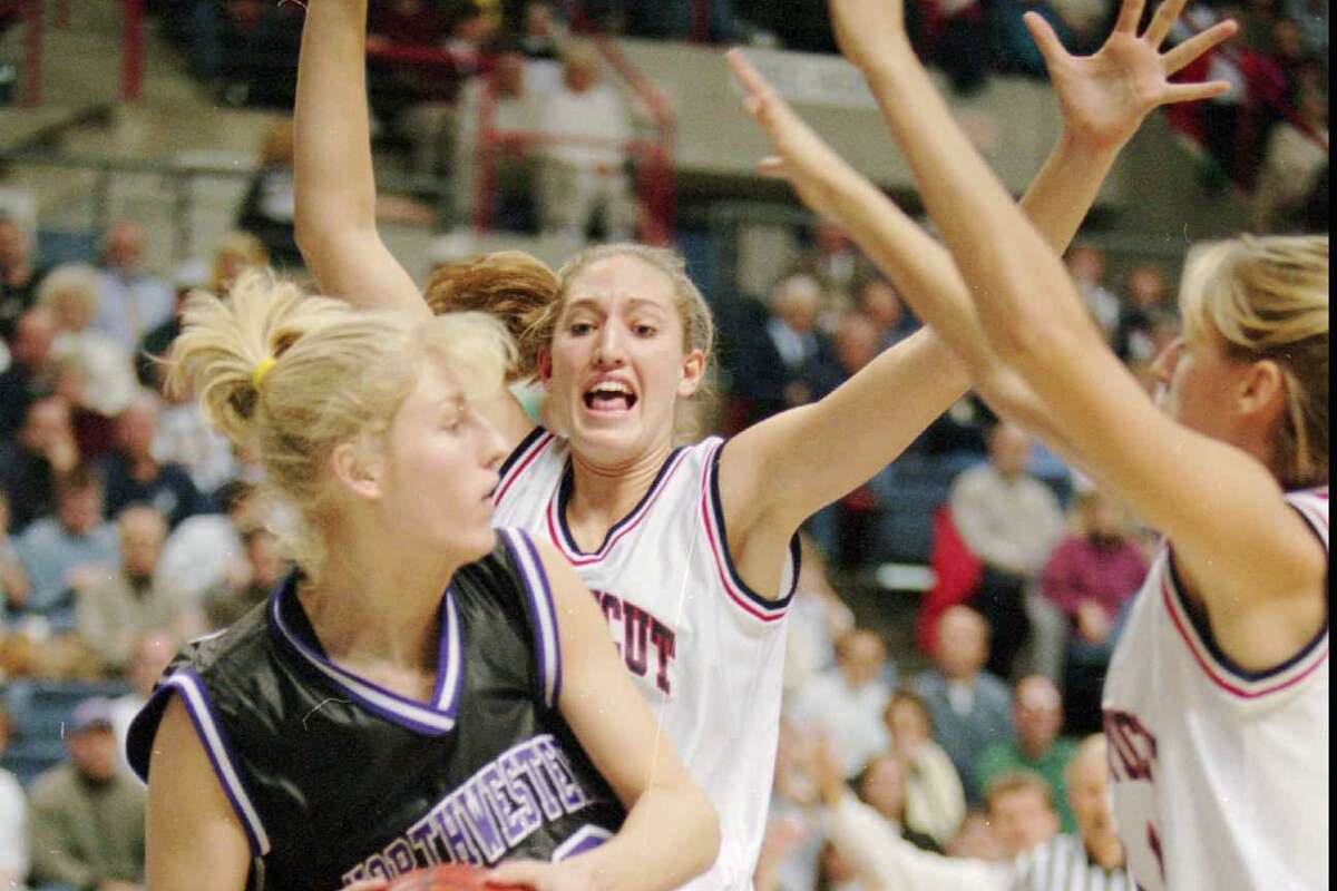Northwestern's Leah Berki, left, has nowhere to go as she is blocked by Connecticut's Kelly Schumacher, center, and Kelly Hunt during first quarter action at Gampel Pavilion in Storrs, Conn. Thursday, Nov. 20, 1997. (AP Photo/Richard Mei)