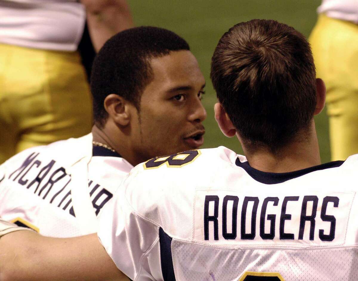Cal quarterback Aaron Rodgers, right, talks to injured WR Geoff McArthur during the first half of the Insight Bowl against Virginia Tech, Friday, Dec. 26, 2003, in Phoenix. California won 52-49.