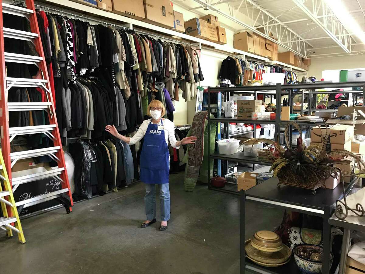 A volunteer poses as she works at the Memorial Assistance Ministries flagship resale shop in Houston.