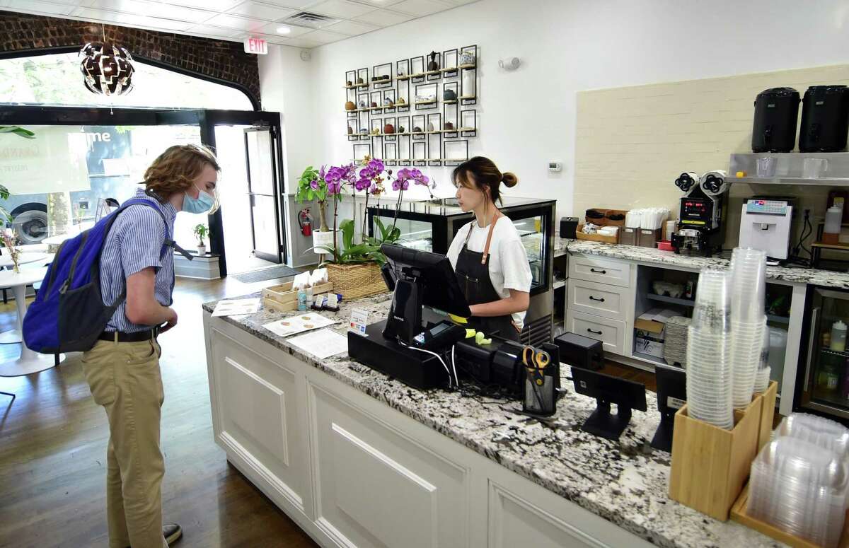 Sabrina Yang takes an order from customer Liam Wilcox at Shiro Desserts and Drinks on Bedford Street in Stamford, Conn., on Tuesday May 24, 2022. Shiro, which offers Asian-inspired desserts and tea drinks, was opend last week by Yang, a student at UConn Stamford majoring in business management.
