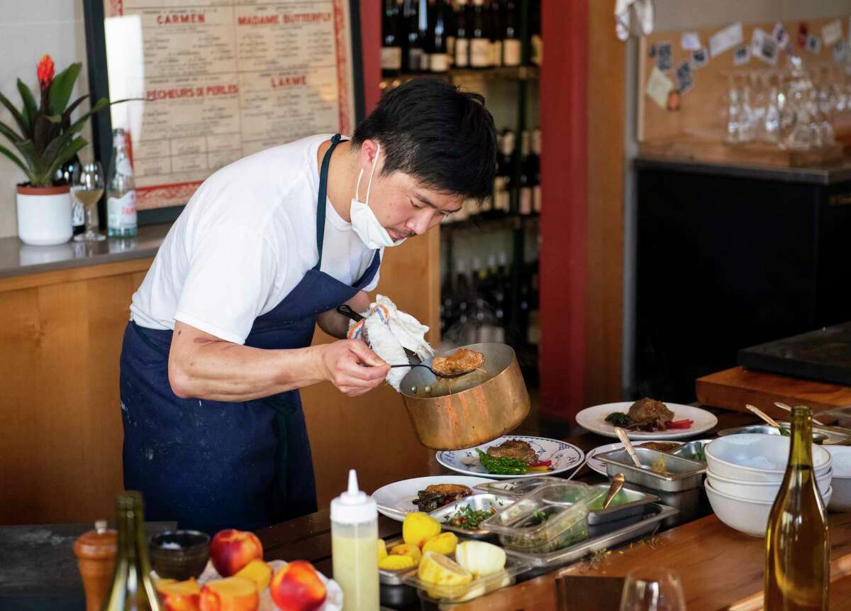 Kosuke Tada, chef-owner of Mijoté, prepares a main course of lamb with piquillo peppers and lemon at Mijoté in San Francisco.