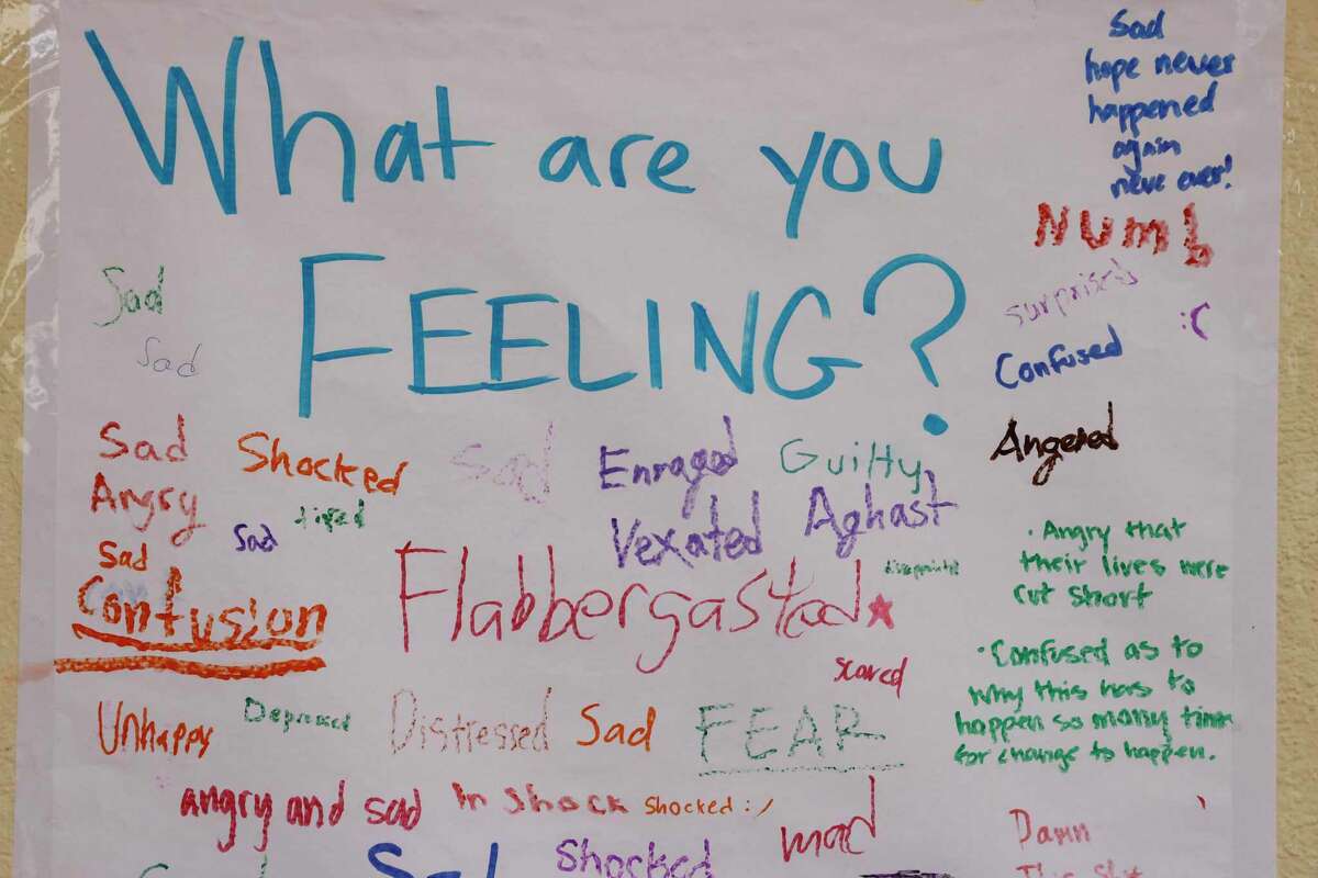 A poster encouraging students to share their feelings is filled with students’ thoughts next to a memorial for the victims of the school shooting in Texas created by students and staff at Abraham Lincoln High School on Wednesday, May 25, 2022 in San Francisco, Calif.