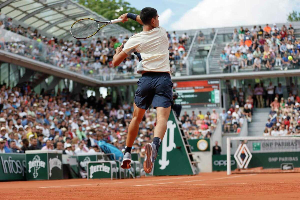 Spain's Carlos Alcaraz slams a forehand to Spain's Albert Ramos-Vinolas during their second round match of the French Open tennis tournament at the Roland Garros stadium Wednesday, May 25, 2022 in Paris. (AP Photo/Jean-Francois Badias)