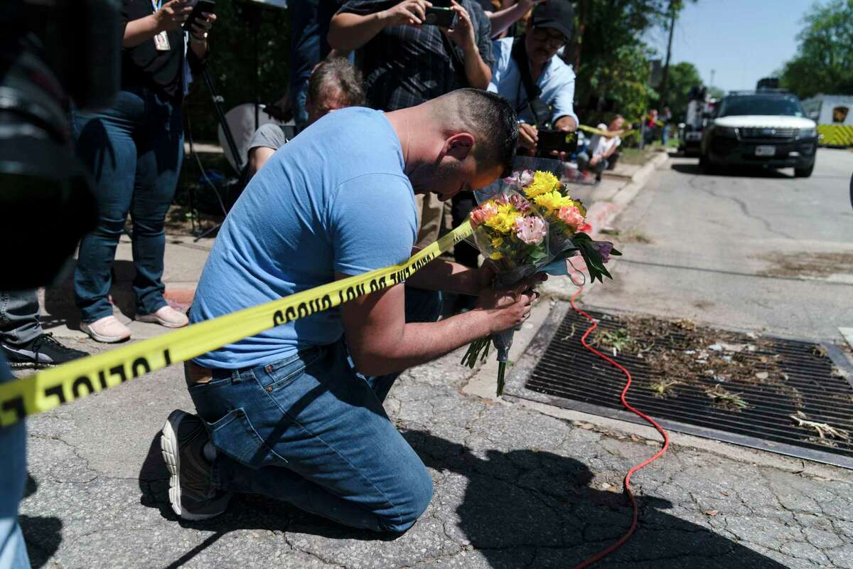 Joseph Avila prays on Wednesday outside of Robb Elementary School in Uvalde, Texas. Authorities said an 18-year-old gunman barricaded himself in a classroom Tuesday and began shooting, killing 19 fourth-graders and their two teachers.