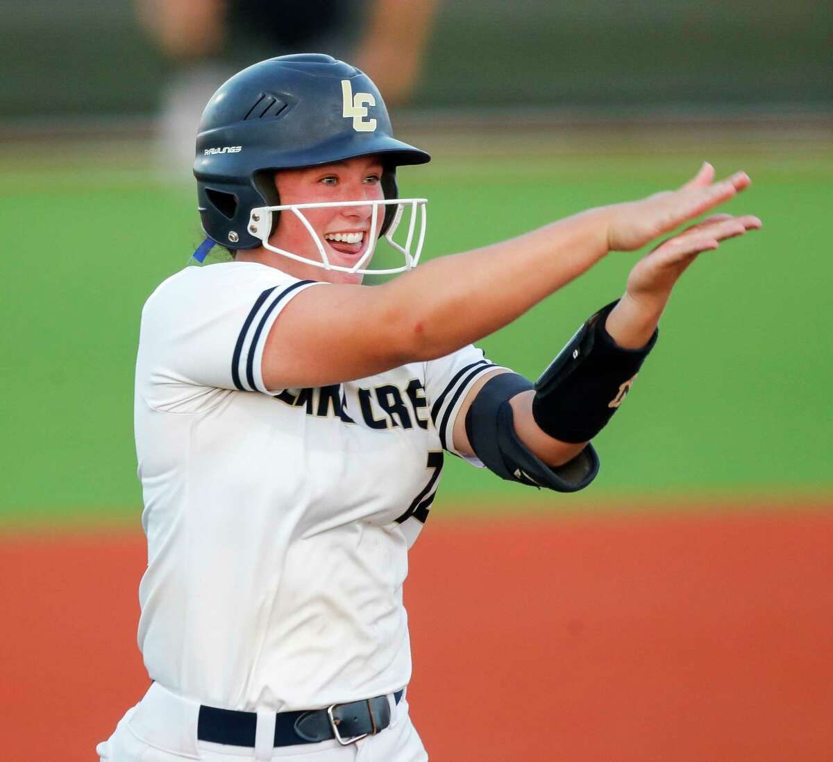 Ava Brown #22 of Lake Creek reacts after hitting a two-run home run in the fifth inning of Game 1 of a Region III-5A championship series at C.E. King High School, Wednesday, May 25, 2022, in Houston.
