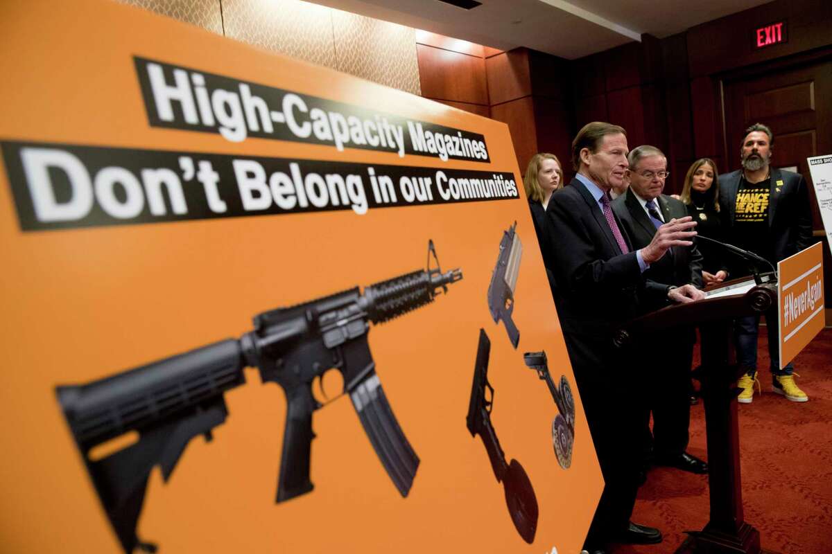 Sen. Richard Blumenthal, D-Conn., center, accompanied by Sen. Bob Menendez, D-N.J., third from right, speaks at a news conference on an proposed amendment to ban high capacity magazines in guns, on Capitol Hill, Tuesday, Feb. 12, 2019, in Washington.