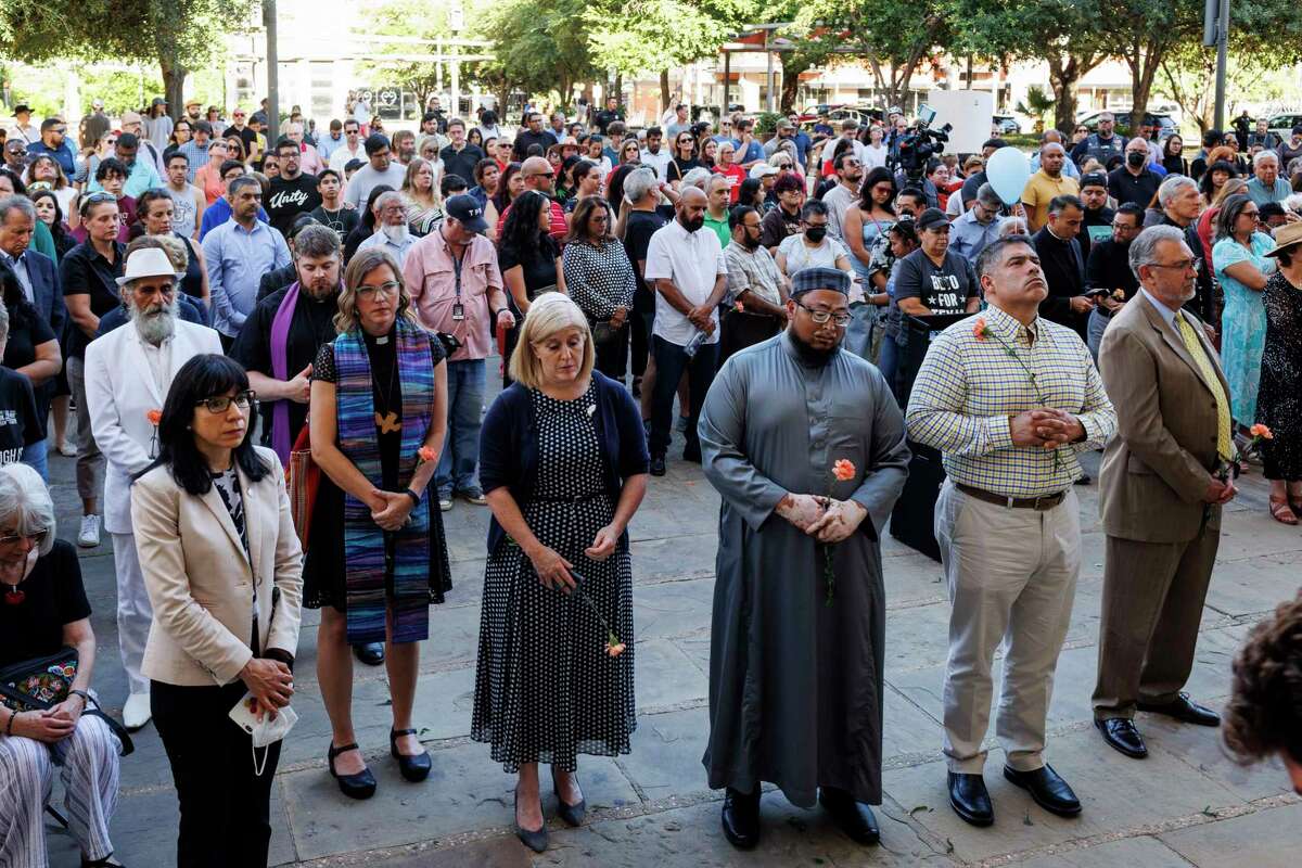 People gather for a prayer vigil outside of San Fernando Cathedral in Downtown San Antonio, Texas, Wednesday, May 25, 2022, to honor the 21 victims who died in a mass shooting at a Uvalde Elementary School on Tuesday. The crowd stood in silence for 21 minutes as they thought about Uvalde, a community located about 80 miles west of San Antonio.