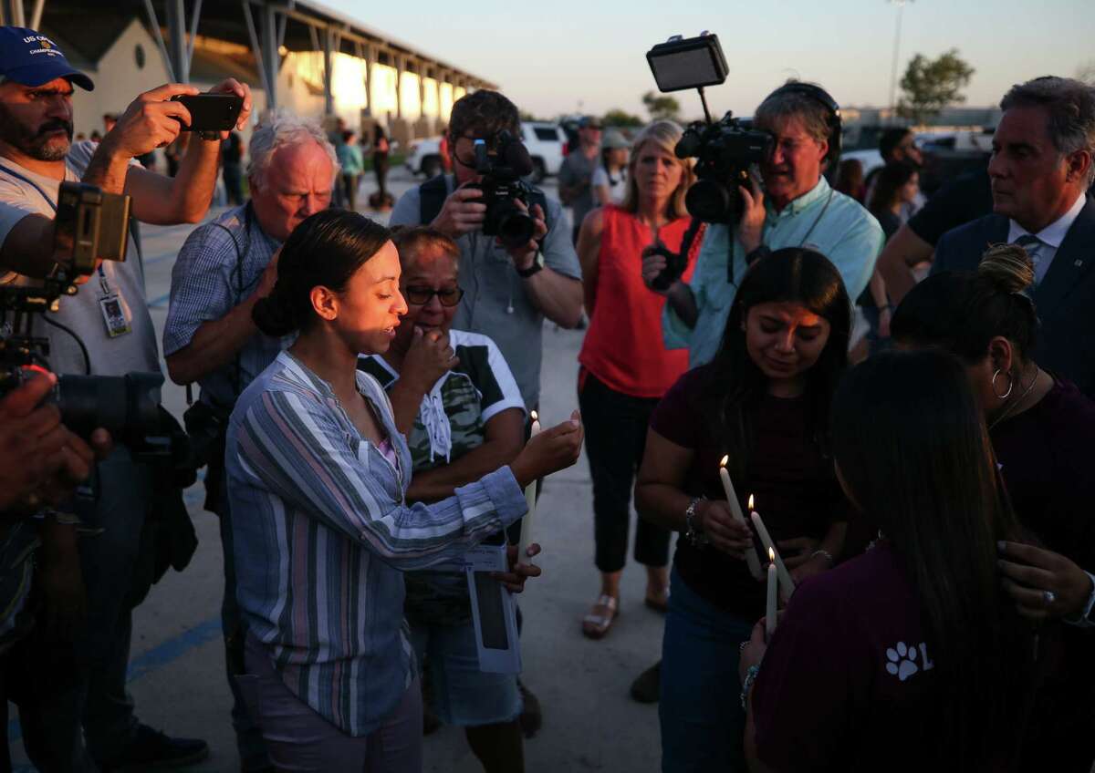 Women and girls light candles for a moment of prayer outside the Uvalde County Fairplex after a vigil held in remembrance of the 21 people – including 19 children – who were killed at the Robb Elementary School mass shooting, on Wednesday, May 25, 2022, in Uvalde, Texas.