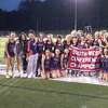 New Fairfield’s girls lacrosse team poses with the SWC championship banner at Pomperaug’s Ed Arum Field in Southbury, Conn., on May 25, 2022. New Fairfield defeated Weston 9-6 in the championship game.