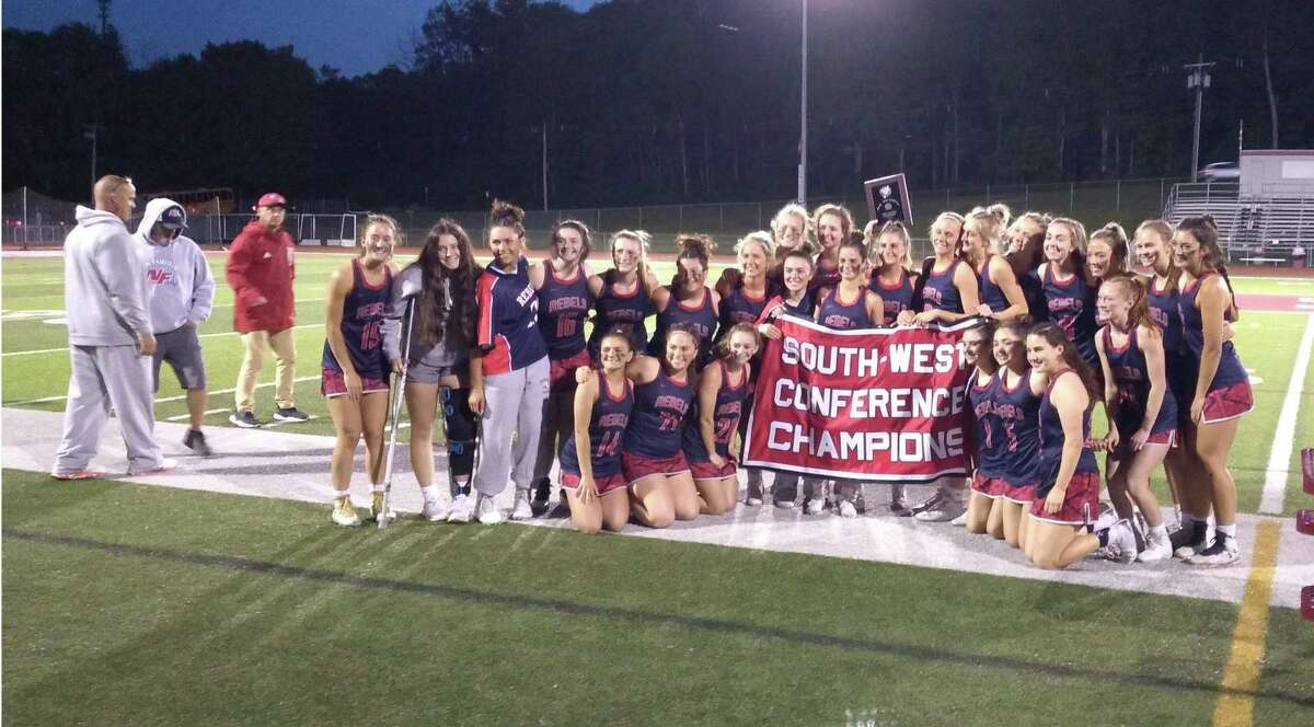 New Fairfield’s girls lacrosse team poses with the SWC championship banner at Pomperaug’s Ed Arum Field in Southbury, Conn., on May 25, 2022. New Fairfield defeated Weston 9-6 in the championship game.