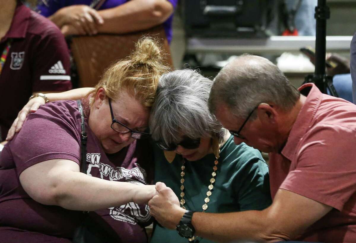 People embrace in prayer during the vigil held in remembrance of the 21 people, including 19 children, who were killed at the Robb Elementary School mass shooting at the Uvalde County Fairplex, on Wednesday, May 25, 2022, in Uvalde, Texas.