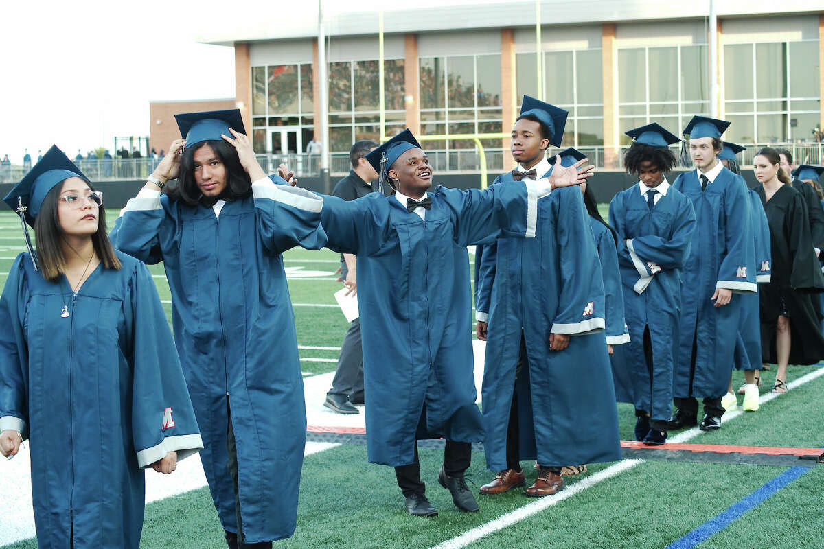 Manvel High School graduating senior Jaquai Neal waves to the crowd as he marches into Alvin ISD Freedom Field for commencement May 25.