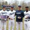 Eastern Connecticut coach Brian Hamm celebrates his 300th victory with grad student pitcher Tommy Benincaso, senior pitcher Aidan Dunn and grad student outfielder John Mesagno.