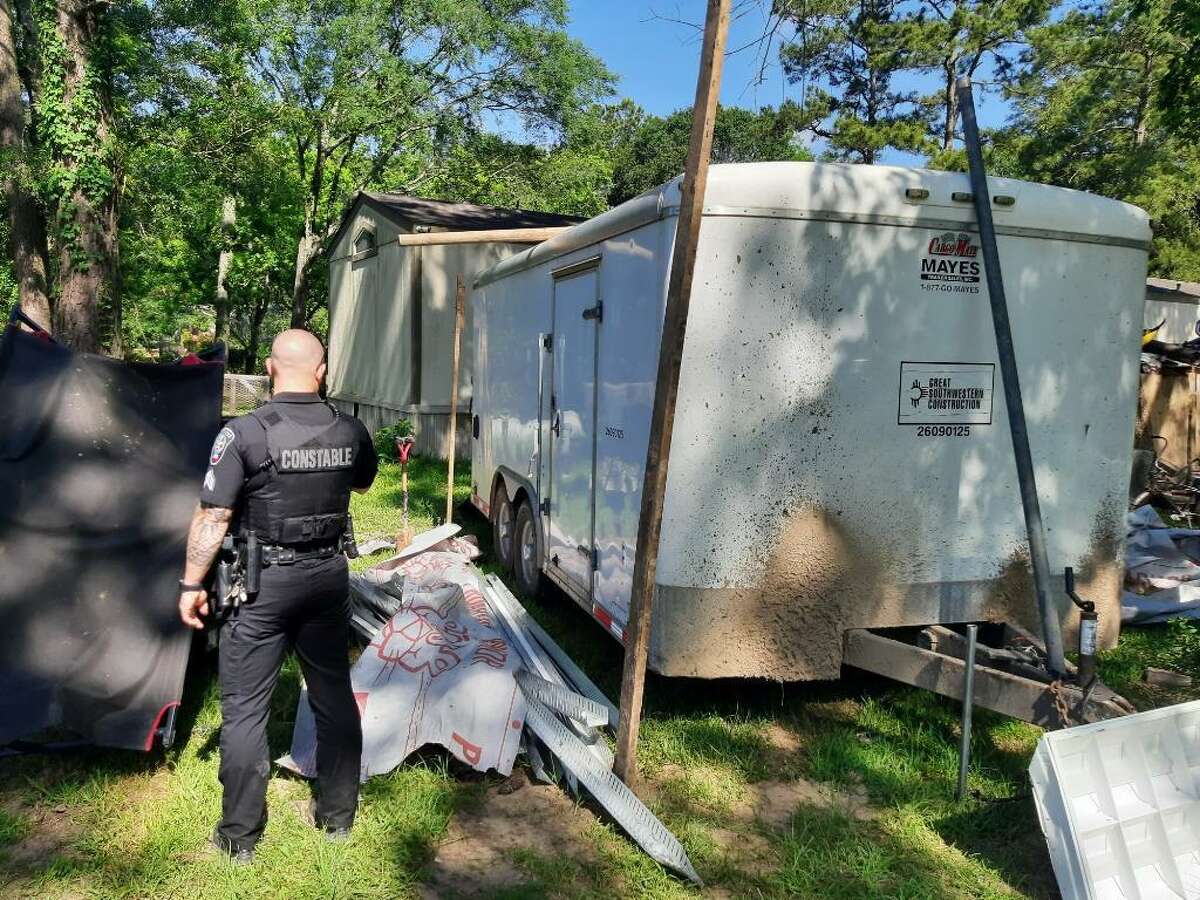 A Montgomery County Precinct 4 Constable's deputy is seen on the scene of a multiple stolen property seizure May 12 in New Caney.