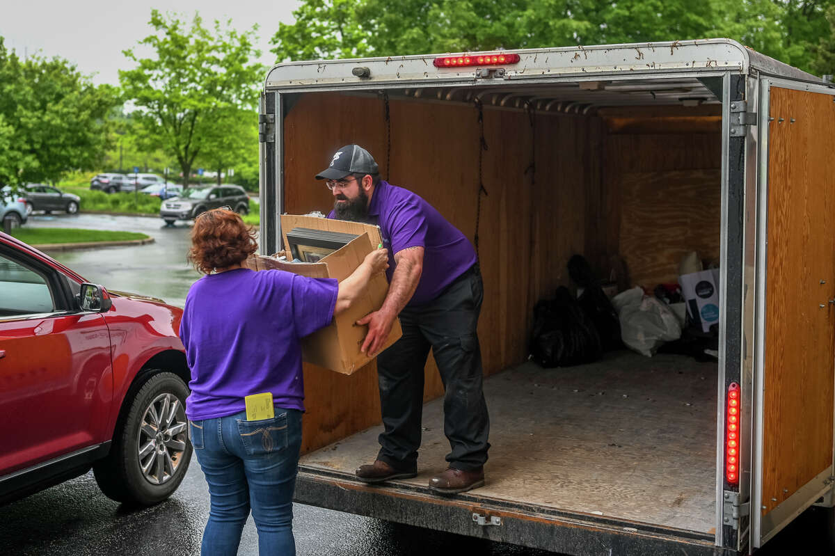 Volunteers and employees of Shelterhouse receive donations ahead of the Midland 100 Club's quarterly meeting Wednesday, May 25, 2022 at Midland Center for the Arts.