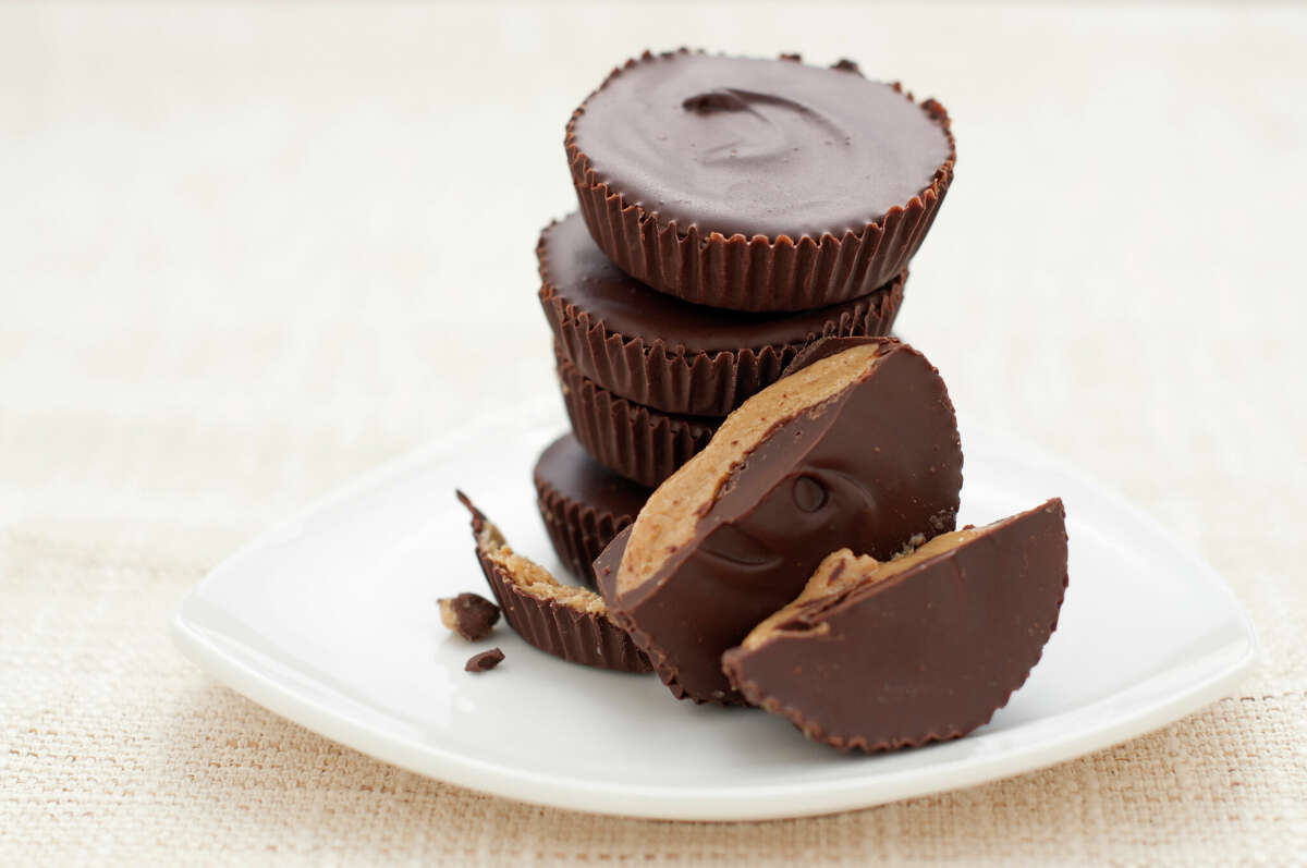 Peanut butter cups are pictured on a miniature plate. 