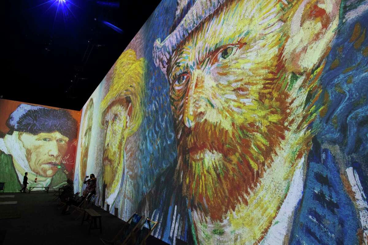 Visitors watch the show, "Van Gogh: The Immersive Experience" in the main gallery at the Armory Studios on Thursday, May 26, 2022, in Schenectady, N.Y. (Paul Buckowski/Times Union)