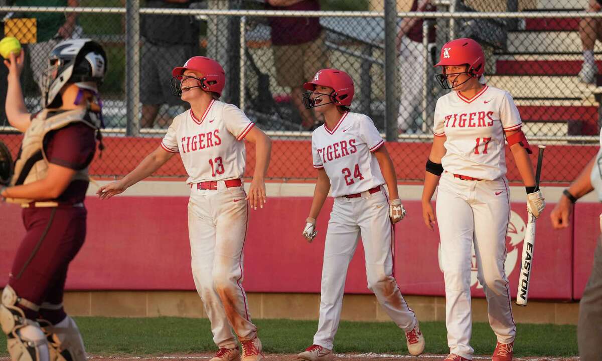 Katy’s Kailey Wyckoff (13), Ashlee Piraneo (24), and Montgomery Henderson (17) celebrate Ashtyn Reichardt’s four run hit to beat Cinco Ranch 10-0 in the sixth inning during a Region III-6A quarterfinals softball game at Katy High School on Friday, May 13, 2022 in Katy.