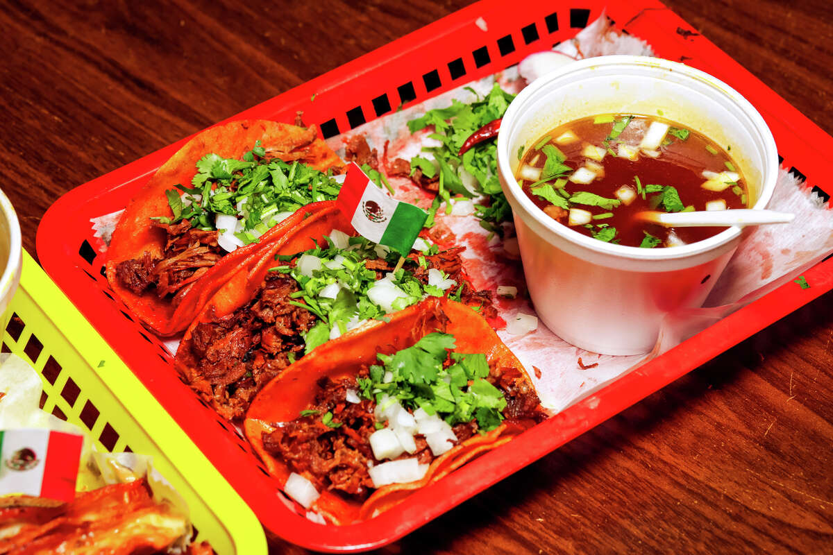 Birria tacos, like the ones at Tacos Doña Lena, are made with tortillas that are dipped in red consommé.