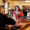 Crazy Vines Winery co-owner Pam Keister, right, chats with customers inside the business Wednesday, May 25, 2022 in Sanford.