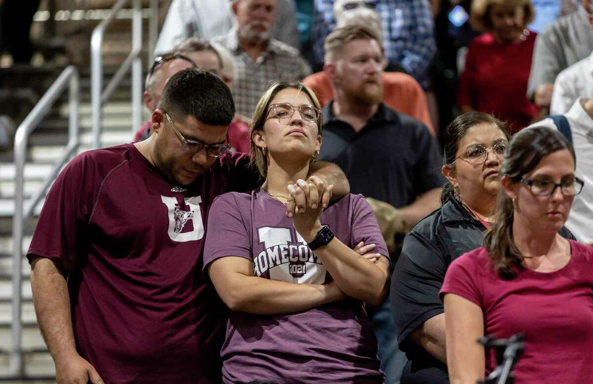 Community members comfort one another during a vigil held in honor of the lives lost at Robb Elementary the day before at the Uvalde County Fairplex Arena in Uvalde, Texas, Wednesday, May 25, 2022. (Josie Norris/The San Antonio Express-News via AP)