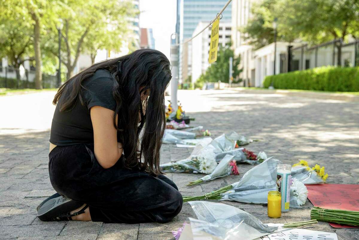 A woman prays at the Governor's Mansion following the mass shooting in Uvalde. Senate Democrats have called on Gov. Greg Abbott to hold a special session to address gun safety.