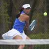 Darien's Lauren Zhang lines up for a backhand shot during a girls tennis match against New Canaan in Darien on Tuesday, May 3, 2022.