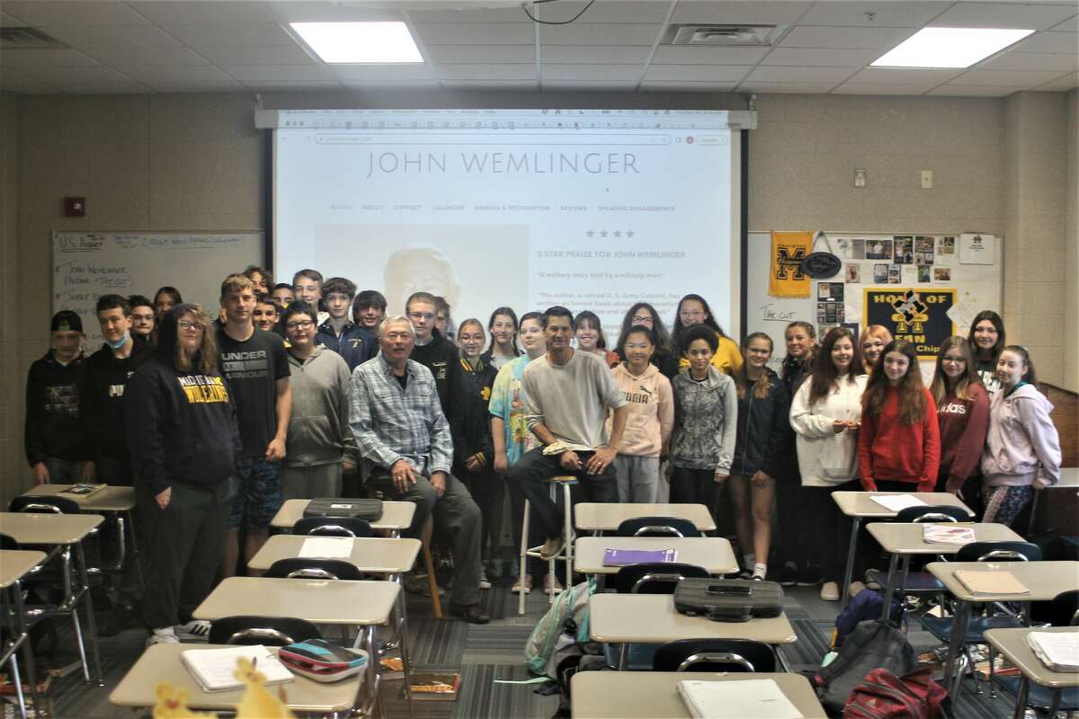 Joe Hendges' first hour history class poses for a photo Thursday with Onekama writer John Wemlinger and retired Manistee Area Public Schools teacher Jerry Brown. Wemlinger and Brown visited the class to discuss Wemlinger's historical novel, "The Cut."