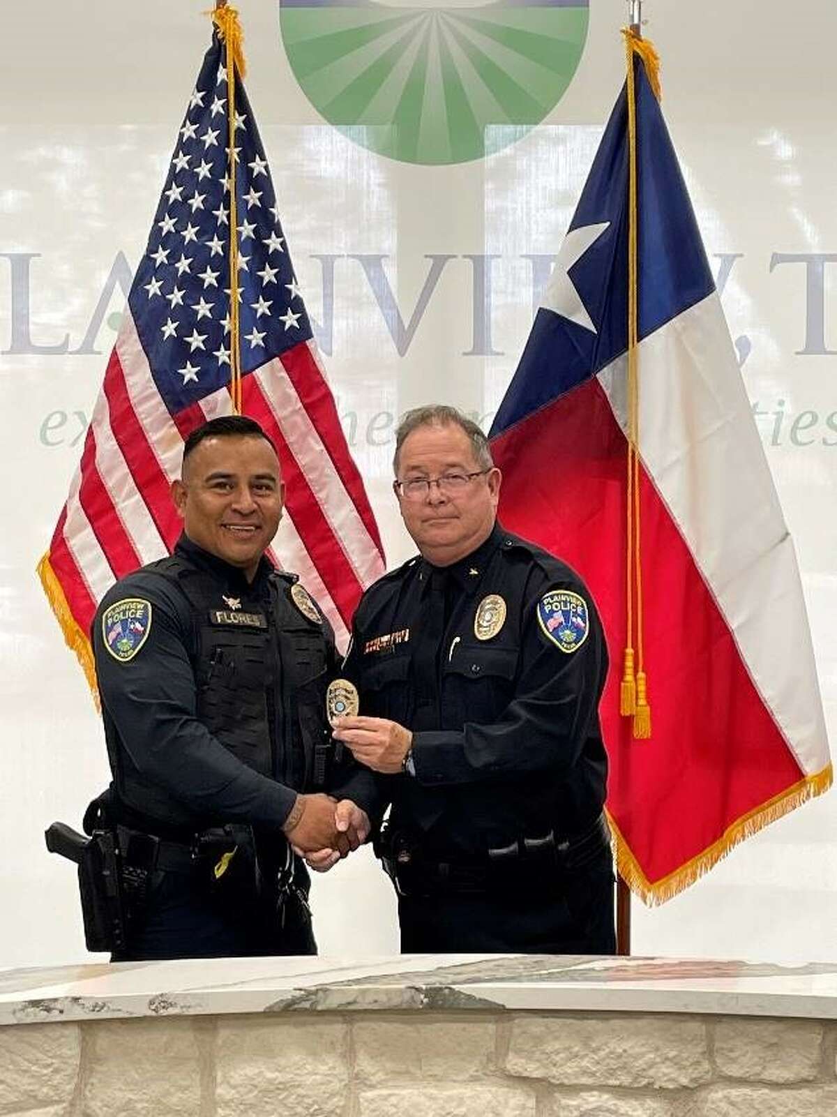 New Cpl. Jose Flores stands with Chief Derrick Watson.