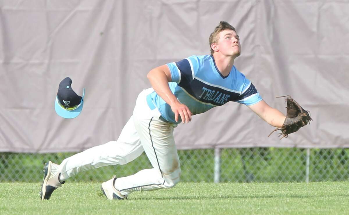 Triopia's Ty Malcomson goes all out to try to make a catch on a sinking line drive in center field during the Trojans' game against Monmouth United in the semifinals of the Jacksonville Routt Sectional on Wednesday.