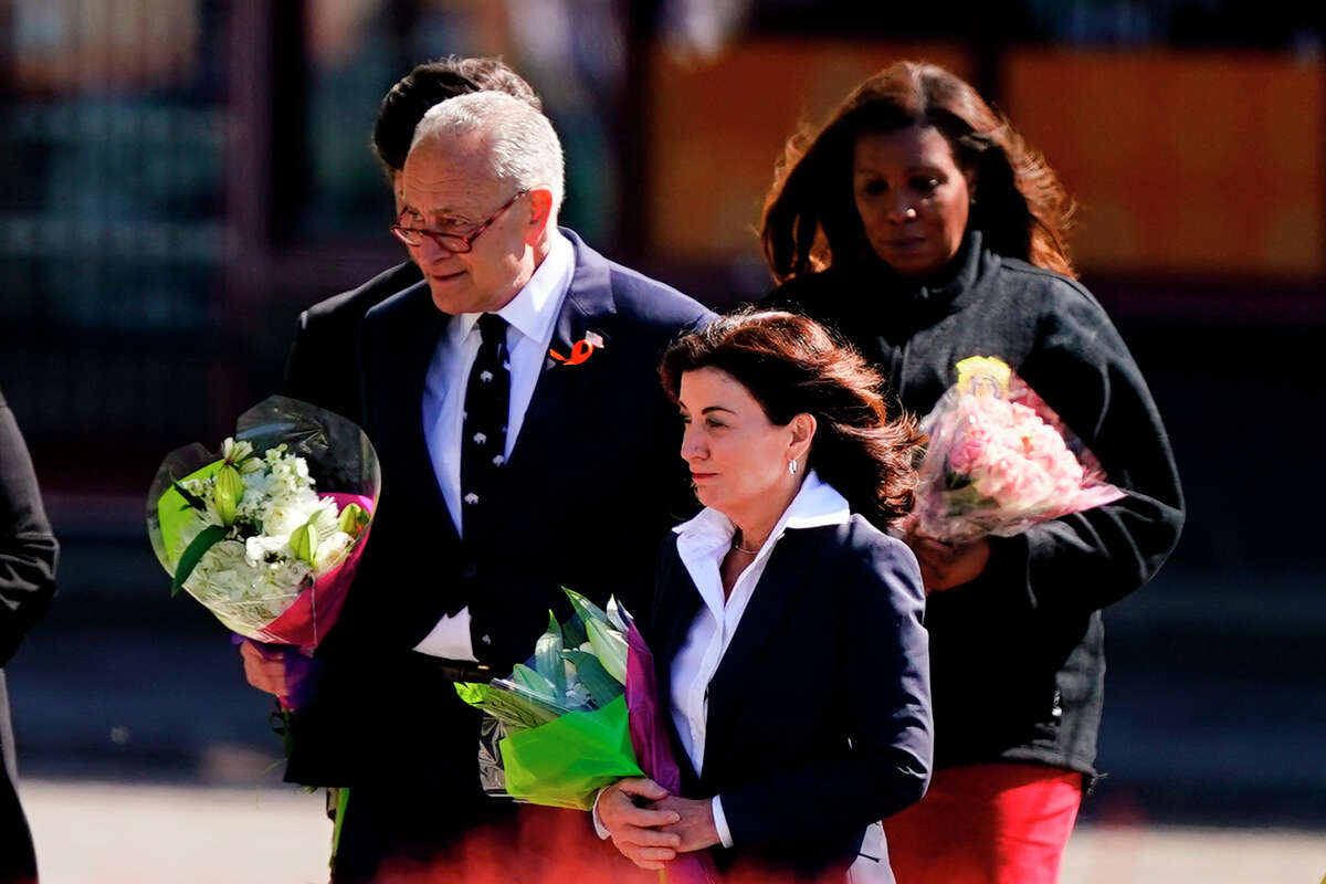 Senate Majority Leader Chuck Schumer of N.Y., New York Gov. Kathy Hochul, and New York Attorney General Letitia James, visit the scene of a shooting at a supermarket to pay respects and speak to families of the victims of Saturday's shooting in Buffalo, N.Y., Tuesday, May 17, 2022. (AP Photo/Matt Rourke)