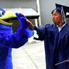 Avery Roach, an Advanced Manufacturing graduate from Wallingford, is greeted by the Hunter Hawk mascot after receiving his diploma during Commencement for the Housatonic Community College Class of 2022, held at the Hartford Healthcare Amphitheater in Bridgeport, Conn. May 26, 2022.
