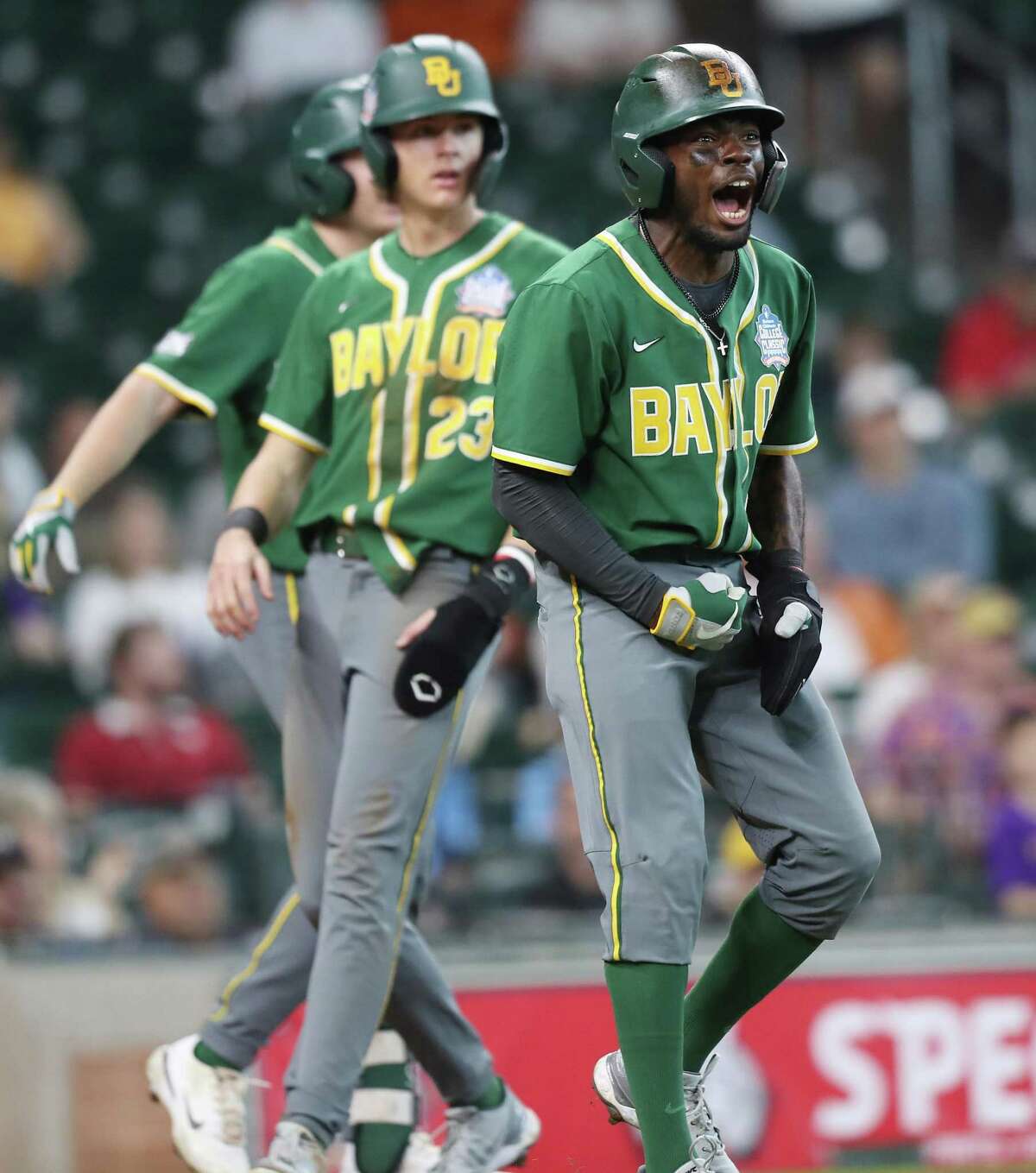 Baylor infielder Tre Richardson (0) celebrates after scoring off of a two-run single hit by Baylor infielder Antonio Valdez (3) in the first inning making the score 3-0 against Tennessee during the Shriners Children’s College Classic at Minute Maid Park on Saturday, March 5, 2022 in Houston .