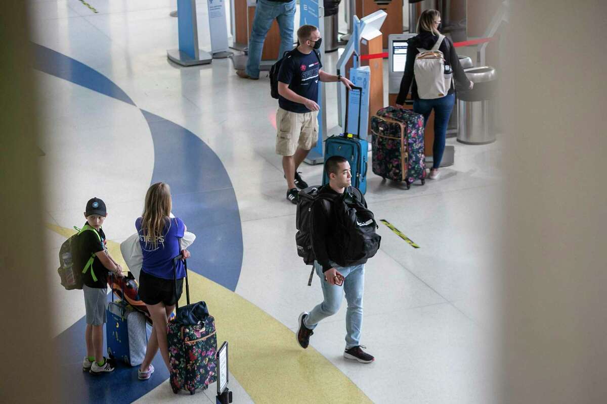Travelers make their way through San Antonio International Airport in April.