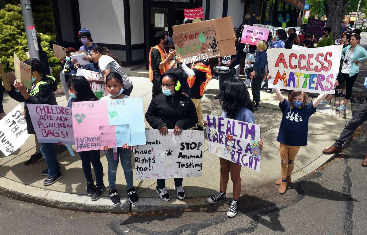 Elm City Montessori School students wait to cross West Rock Avenue during the Children’s March in New Haven Thursday.