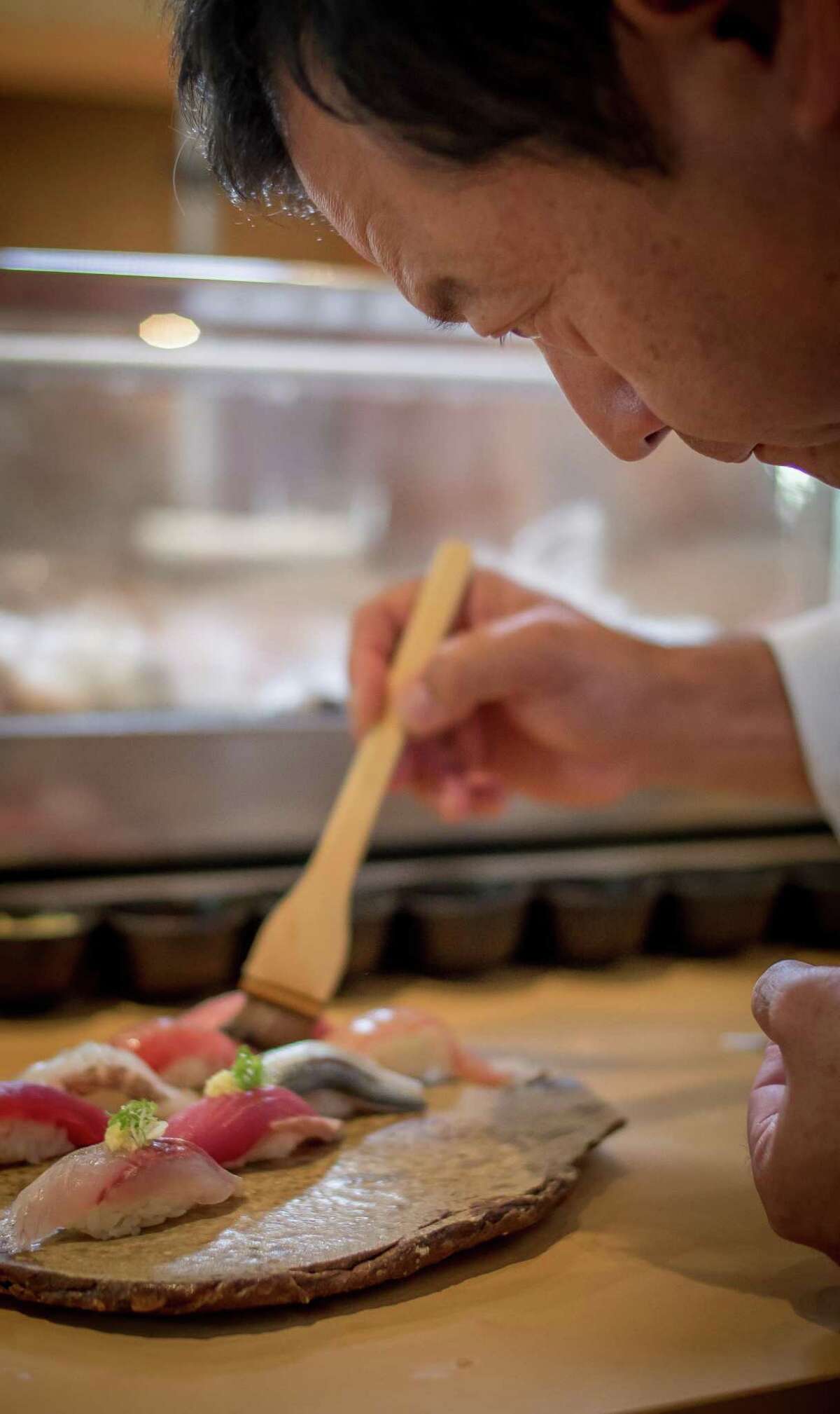 Chef Ken Tominaga prepares sushi at Pabu in San Francisco in 2014.