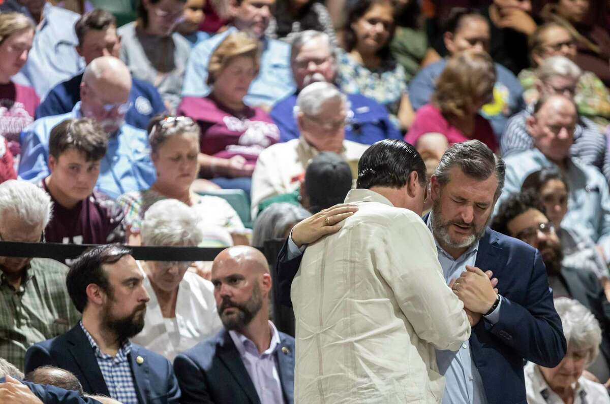 Senator Ted Cruz prays with a community member during a vigil held in honor of the lives lost at Robb Elementary the day before at the Uvalde County Fairplex Arena in Uvalde, Texas, on May 25, 2022.