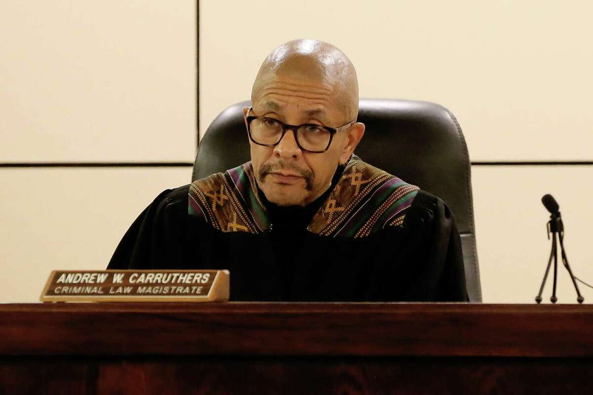 Magistrate Judge Andrew J. Carruthers, shown at a bond hearing in 2019, wears a robe trimmed with African textile colors.