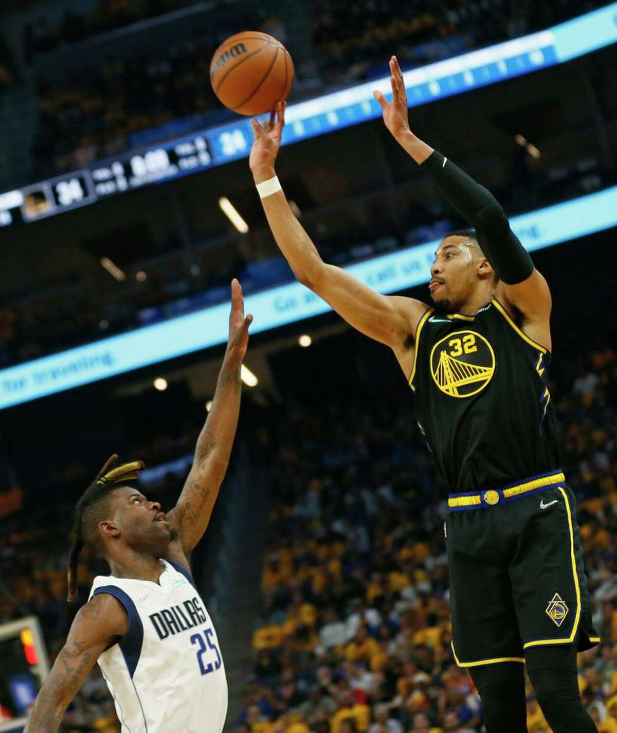 Golden State Warriors forward Otto Porter Jr. (32) attempts a three pointer against Dallas Mavericks forward Reggie Bullock (25) in the second quarter of Game 1 of the NBA Western Conference finals at Chase Center, Wednesday, May 18, 2022, in San Francisco, Calif.