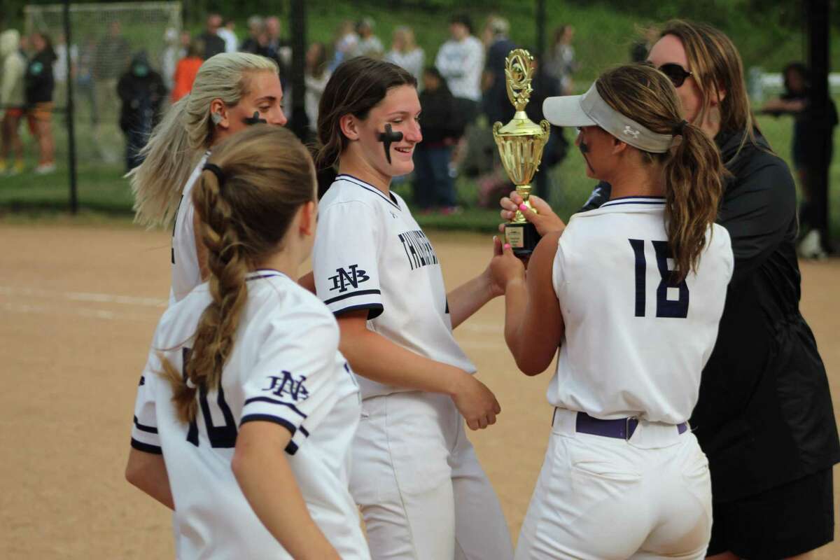 North Branford’s Bella Hills passes off the Shoreline championship trophy to teammates. The senior homered and drove in three runs in North Branford’s 7-2 win over Old Lyme on Thursday.