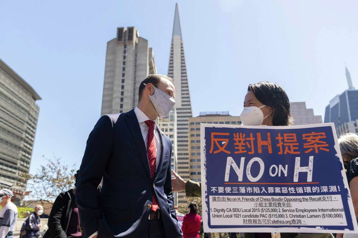 San Francisco District Attorney Chesa Boudin chats with Shaw San Liu of the Chinese Progressive Association Action Fund during a Portsmouth Square rally against the recall.
